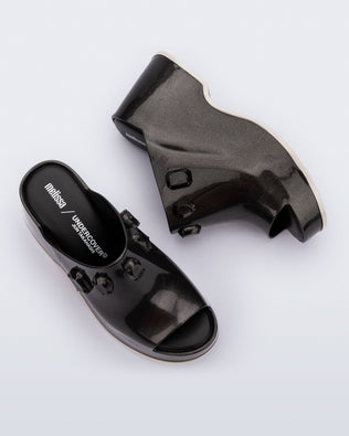 Top and side view of a pair of metallic black Patty Stones + Undercover platform open toe mules with beige sole and stone embellishments on upper.