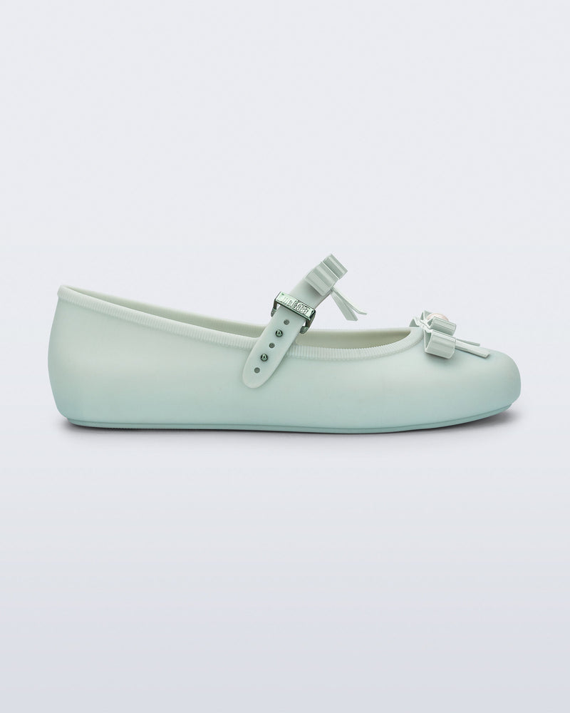 Side view of a green Soft Ballerina Bow with bows and a pearl in the center of each bow