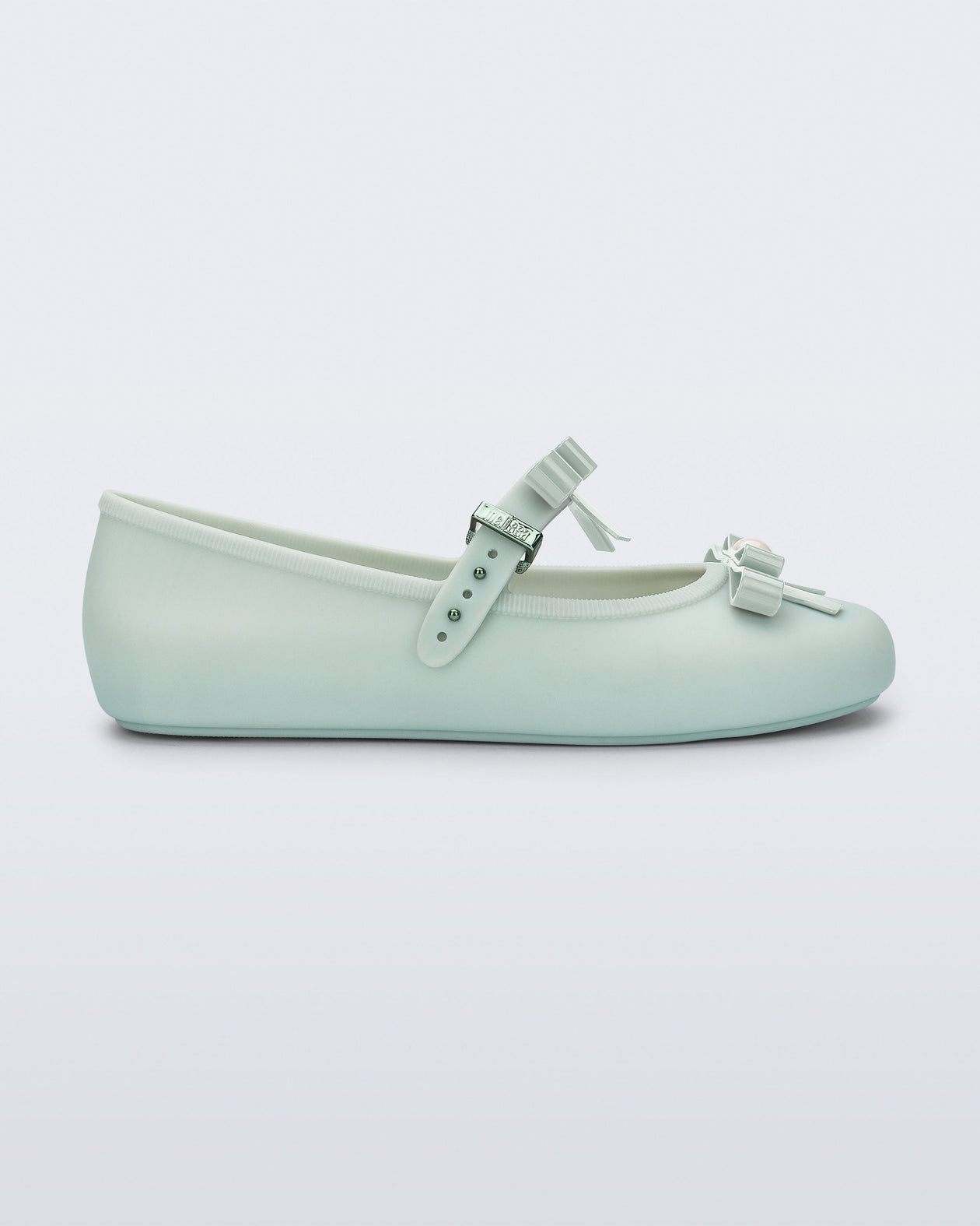 Side view of a green Soft Ballerina Bow with bows and a pearl in the center of each bow