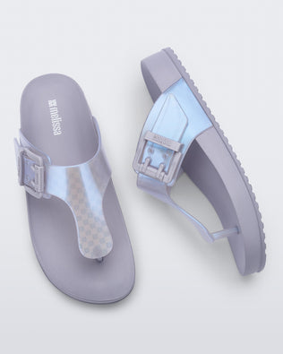 Top and side view of a pair of pearly blue Cozy Flip flops