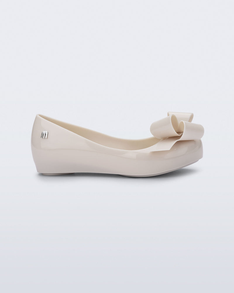Side view of a beige Ultragirl Classy kids ballerina with beige bow.