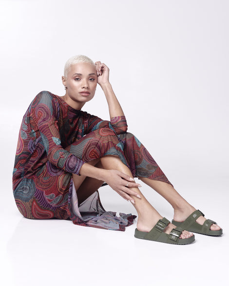 Model wearing a pair of green Cozy M Love adult slides