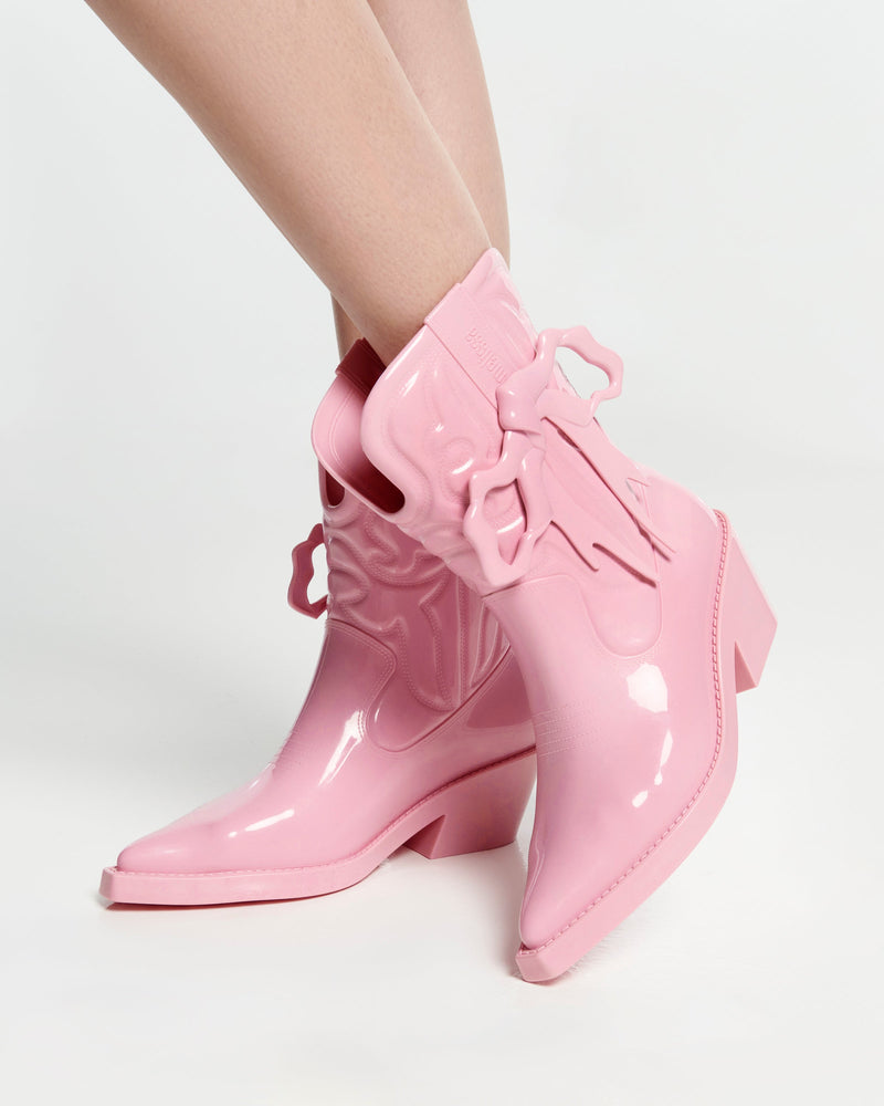 Model's legs in a pair of pink Texas + Maldito boots