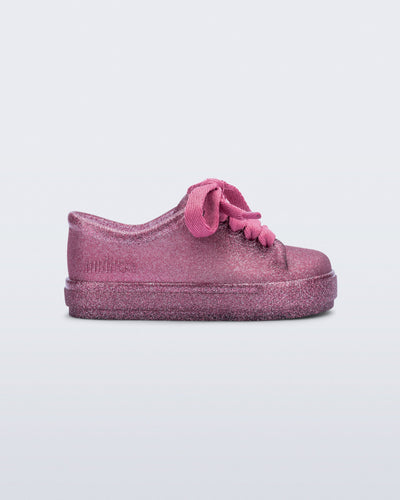 Side view of a glitter pink baby Hip Sneaker with pink laces