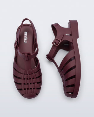 Top and side angled view of a pair of matte burgundy Possession fisherman sandals.