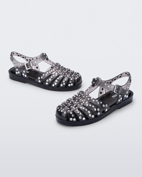 Angled view of a pair of clear black Possession Crystals sandals