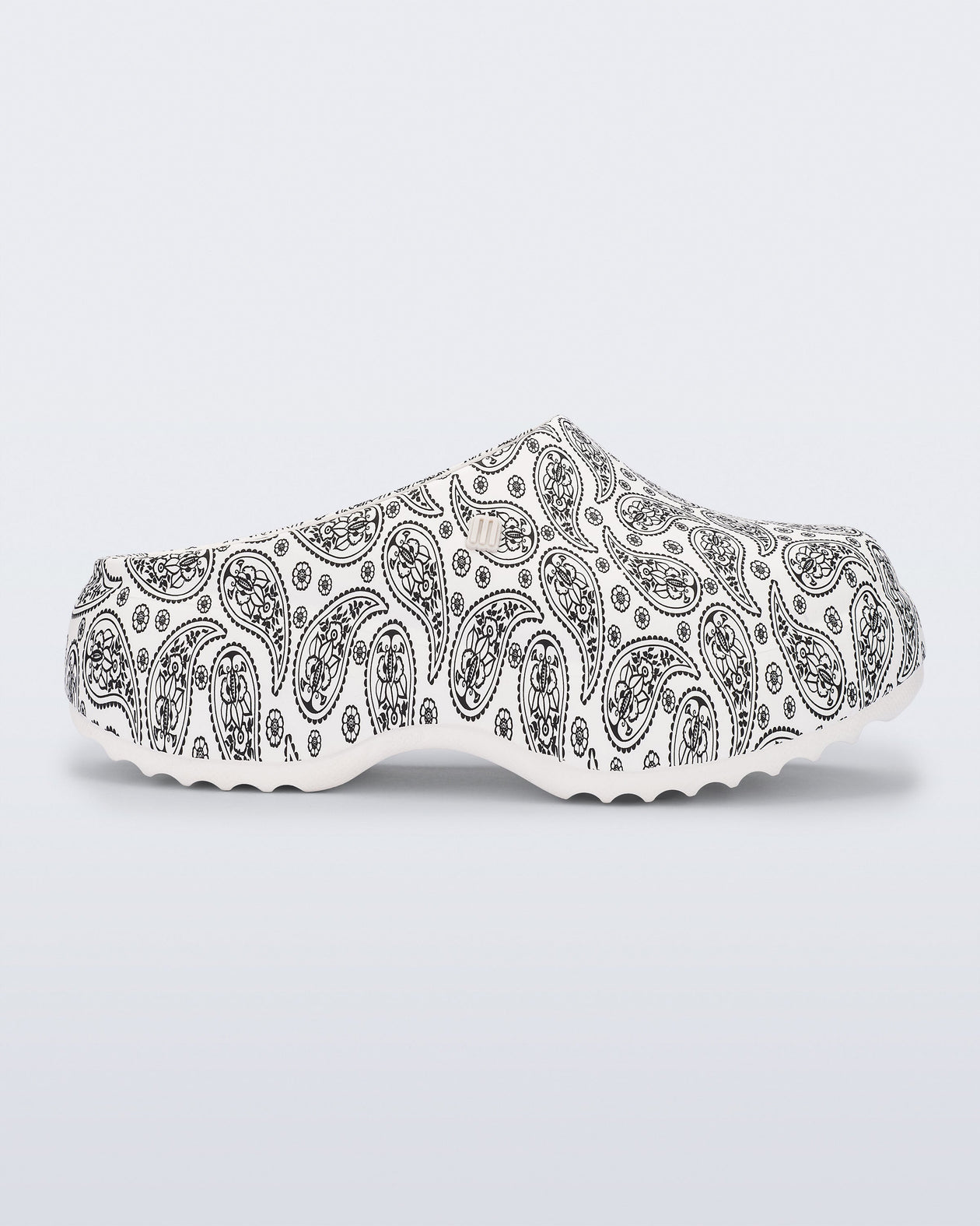 Side view of a white Free Clog Print Platform with black paisley print.