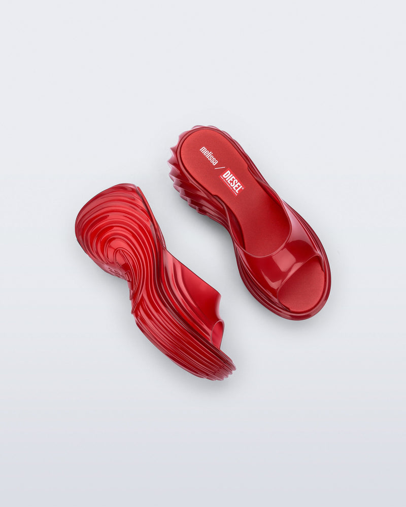 Top and side view of a pair of transparent red Platforms + Diesel slides