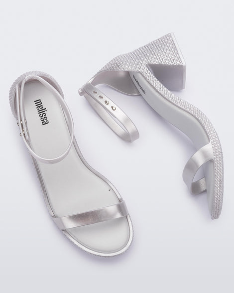 Top and side view of a pair of metallic silver Lux Heels