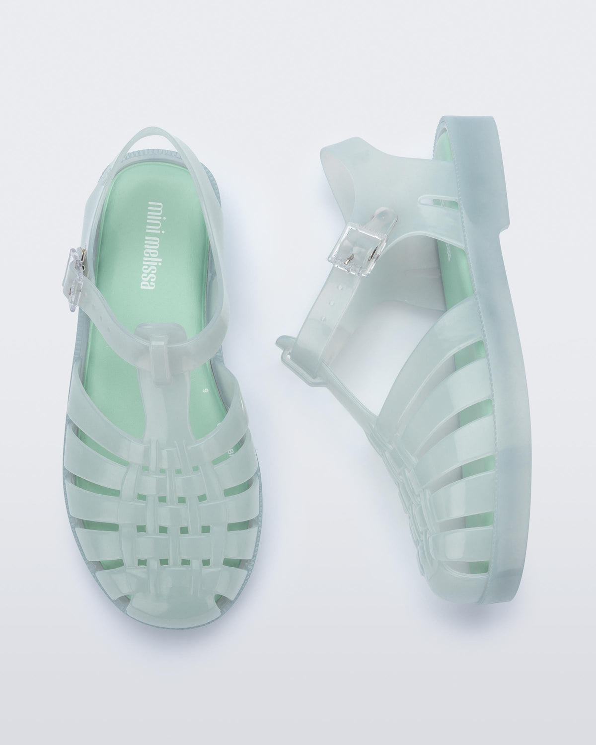 Side and top view of a pair of light green kids Possession sandals.