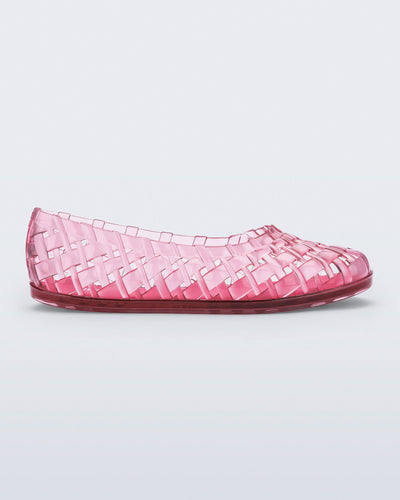 Side view of a clear pink Possession Ballerina flat