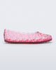 Side view of a clear pink Possession Ballerina flat
