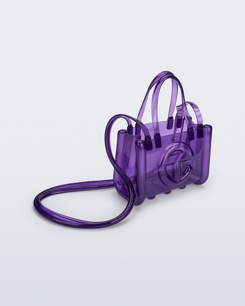 Angled view of the purple Small Jelly Shopper x Telfar bag