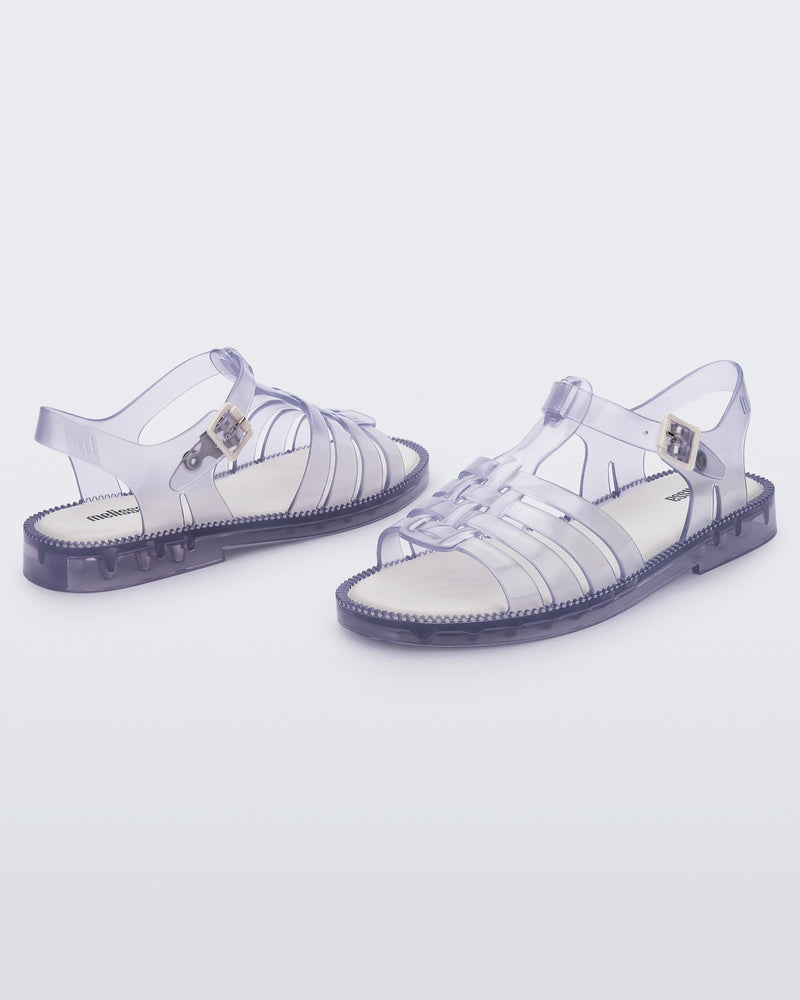 Angled view of a pair of clear Possession Fresh fisherman style sandals with open toe.