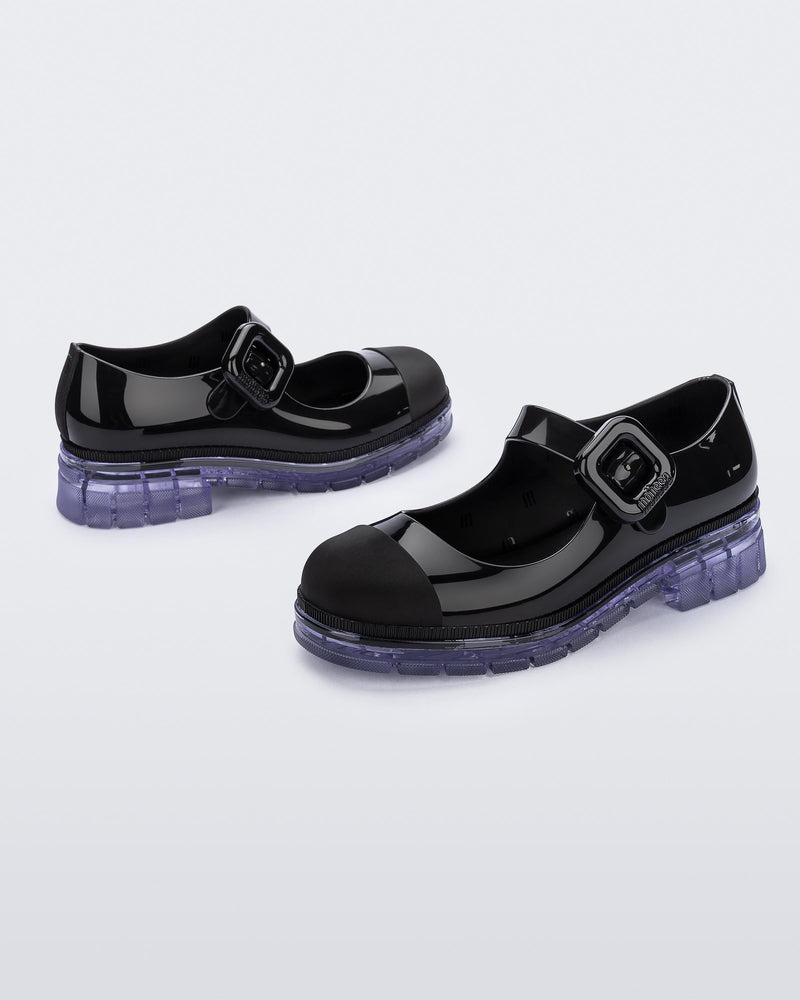 Back and side angle view of a pair of black with clear sole June kids mary janes with matte toe cap