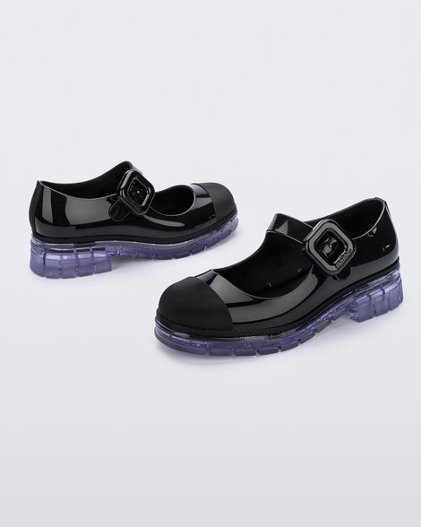 Back and side angle view of a pair of black with clear sole June kids mary janes with matte toe cap