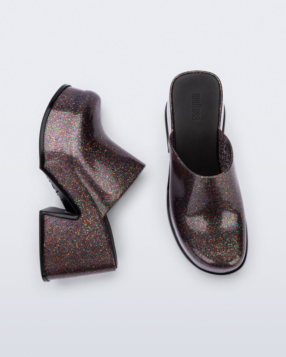 Side and top view of a pair of mixed glitter Mia mules with black sole