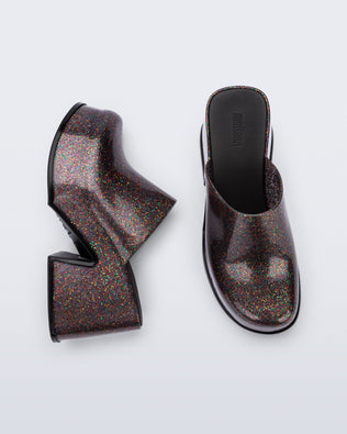 Side and top view of a pair of mixed glitter Mia mules with black sole