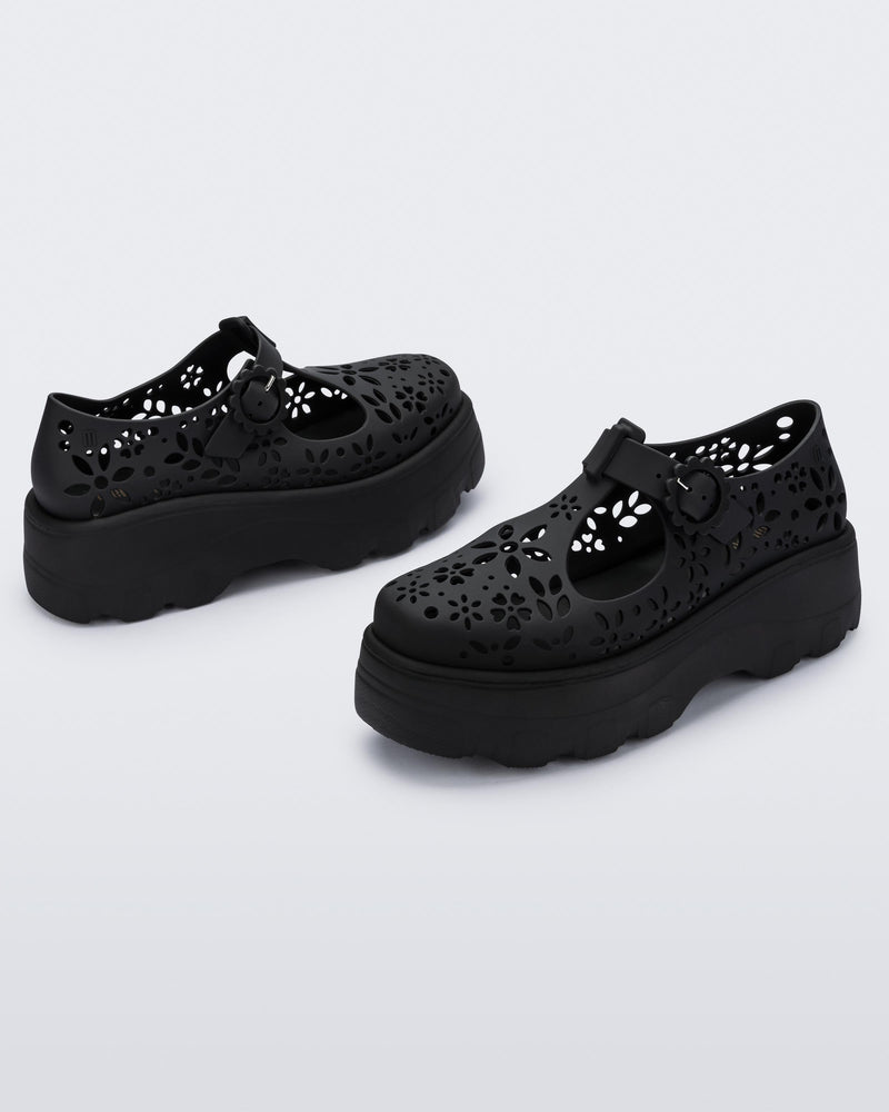 Angled view of a pair of pink Kick Off Lace women's platform shoe with buckle.