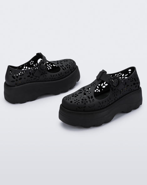 Angled view of a pair of pink Kick Off Lace women's platform shoe with buckle.