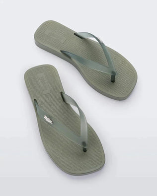 Top view of a pair of green/clear Melissa Sun Long Beach flip flops with a green base and clear green straps with 