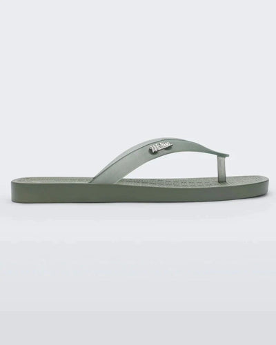 Side view of green/clear Melissa Sun Long Beach flip flop with a green base and clear green straps with "melissa" on the strap.
