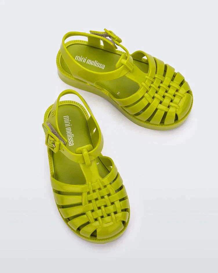 Top view of a pair of green Mini Melissa Possession sandals with several straps and a green base.