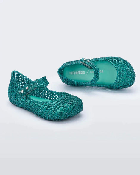 Top and angled view of a pair of Mini Melissa Campana flats for baby in green glitter with an open woven texture.