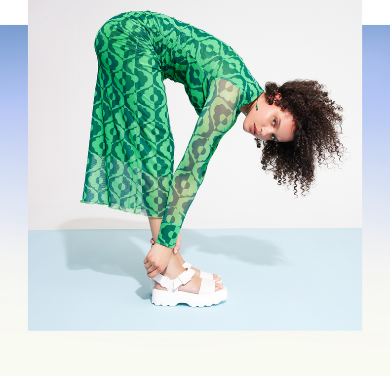 model wearing the white kick off sandal