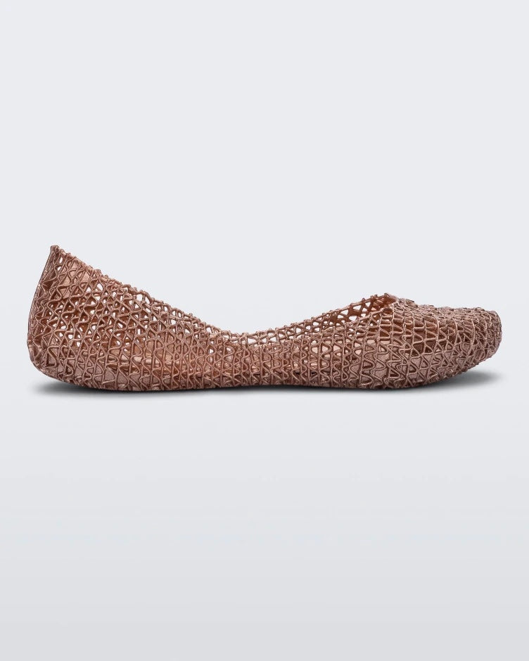A side view of pink Melissa Campana ballet flats. 
