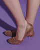 Video with no sound of a model's legs moving around in a pair of metallic rose Campana flats.