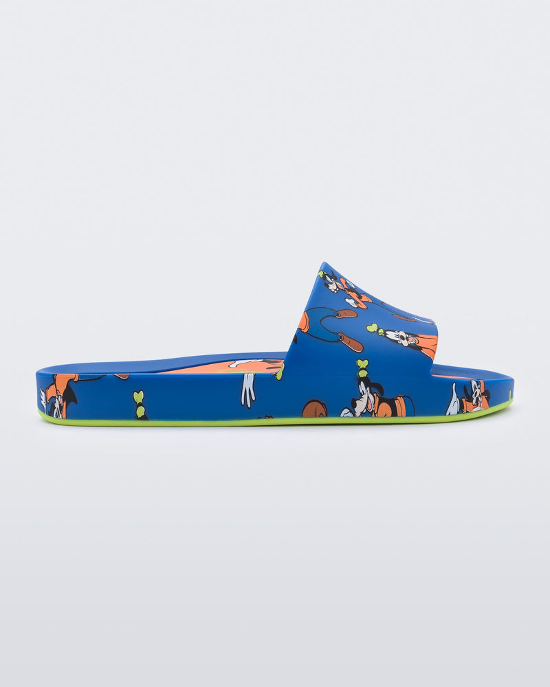 An inner side view of a blue Mini Melissa Beach slide with a blue base and a pattern of Disney's Goofy in different poses.