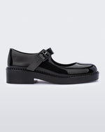 Side view of a black Melissa Lola loafer with a rounded toe and a black strap and buckle.