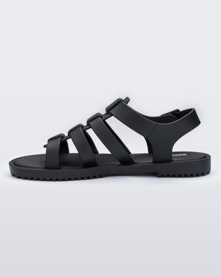 An inner side view of a black Melissa Flox sandal with straps.