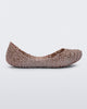An outter side view of a pink metallic Mini Melissa Campana flat with a woven design base.