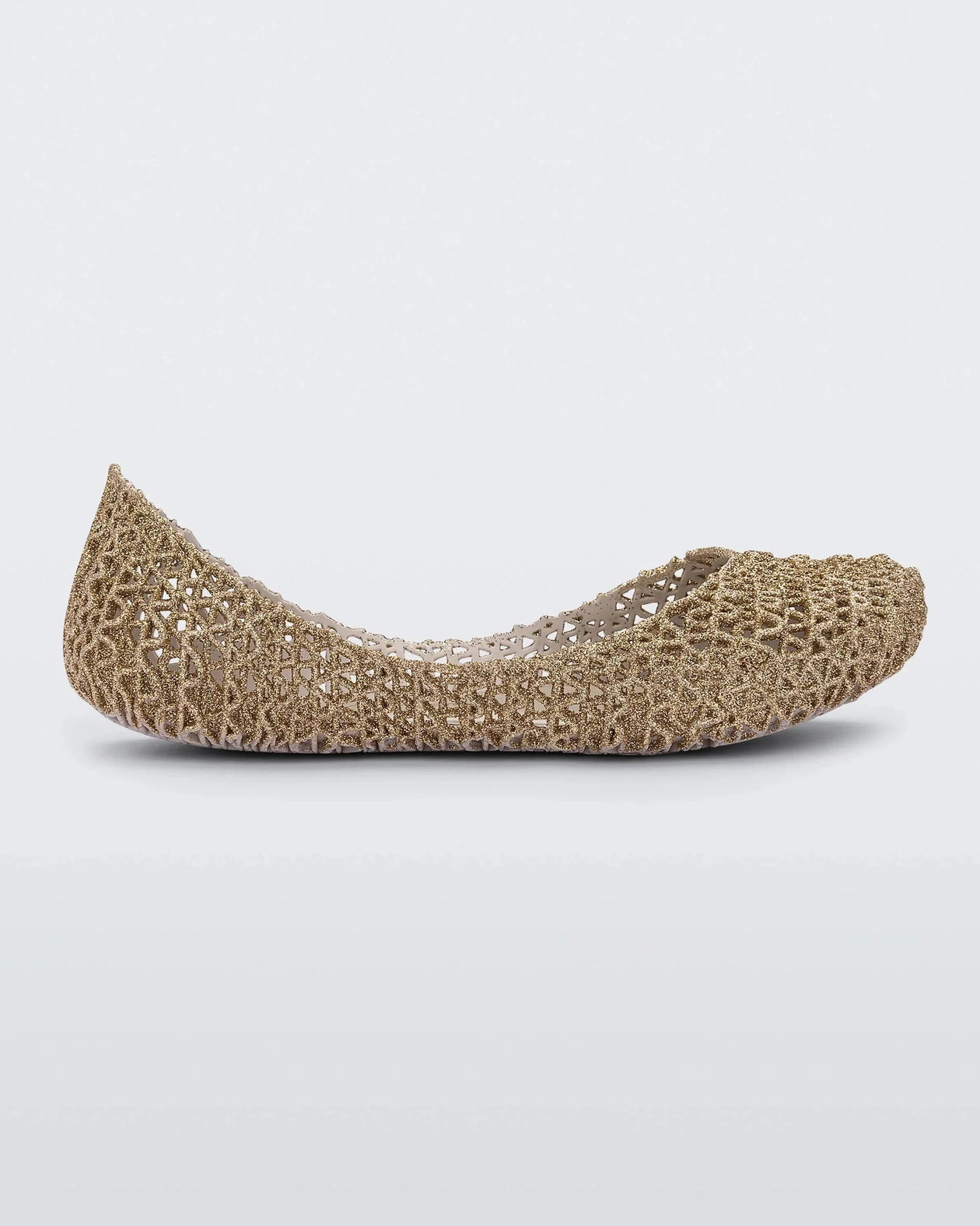 Side view of a white / gold glitter Mini Melissa Campana flat with an open woven texture.