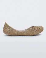 Side view of a white / gold glitter Mini Melissa Campana flat with an open woven texture.