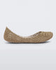 Side view of a white / gold glitter Mini Melissa Campana flat with an open woven texture.