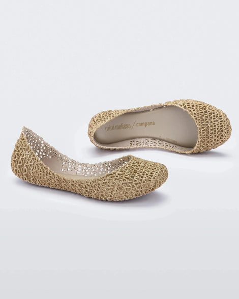 A side and top view of a pair of white / gold glitter Mini Melissa Campana flats with an open woven texture.
