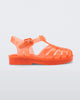 Side view of an orange Mini Melissa Possession sandal with several straps, a closed toe front and a back ankle strap.