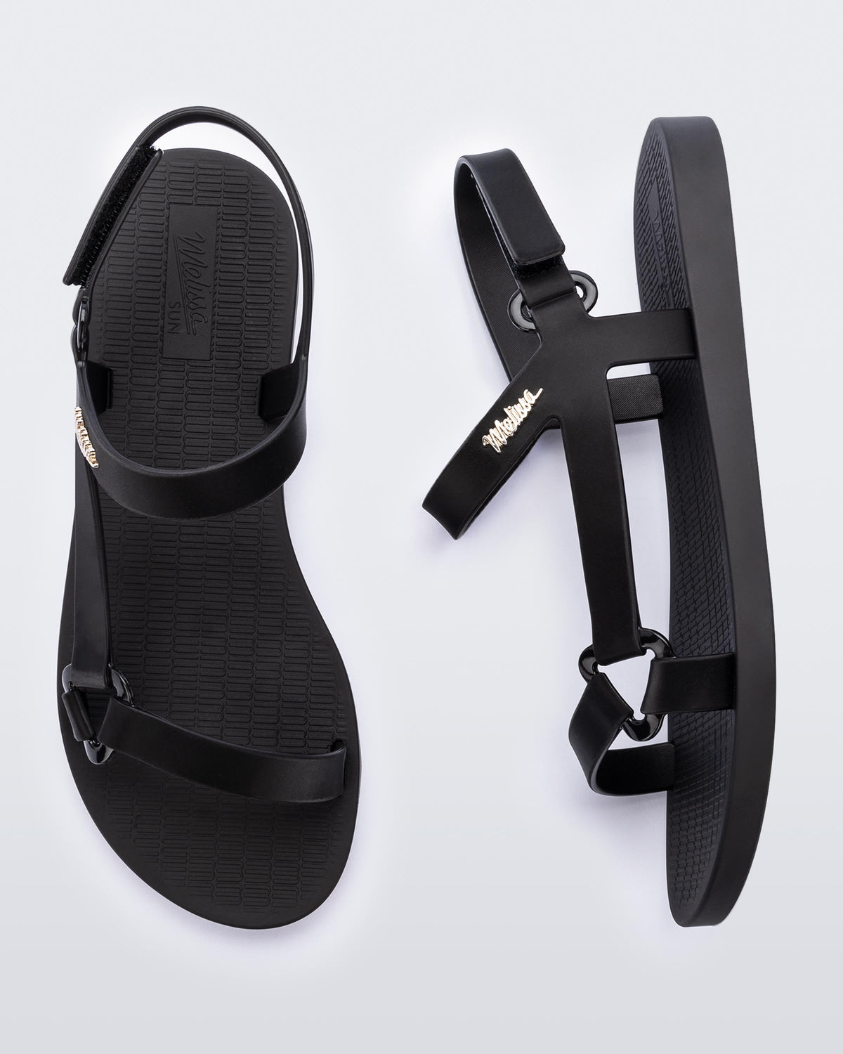 top and side view of a pair of the Melissa Sun Downtown sandals in black.