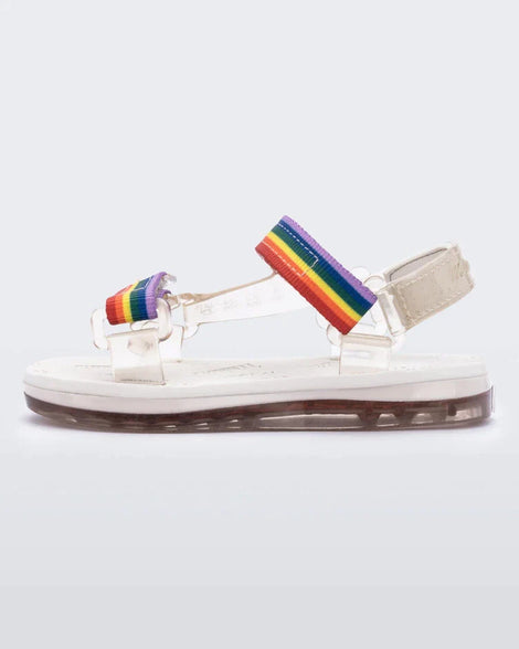Side view of white Mini Melissa Papete sandal with rainbow straps.